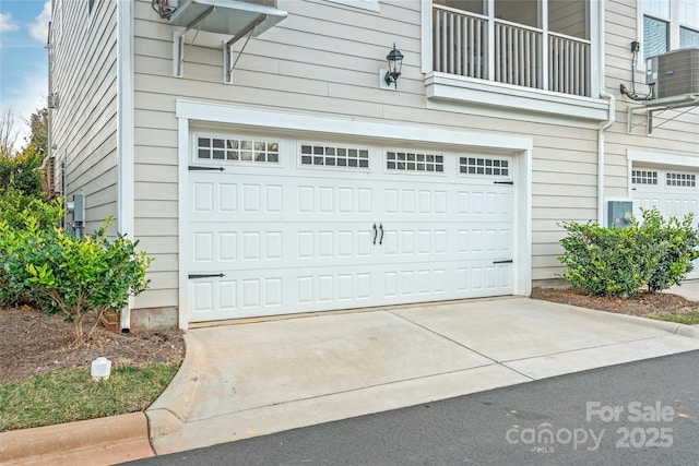 garage with driveway and central AC