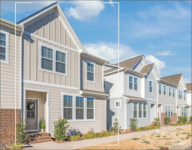 view of property with a residential view and board and batten siding