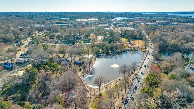 bird's eye view with a water view and a forest view