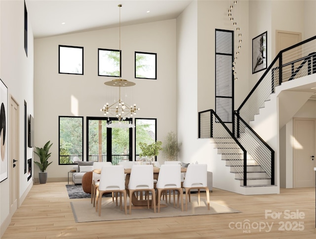 508 Hearthstone Way, Horse Shoe, NC 28742 - dining space featuring stairway, light wood-type flooring, a towering ceiling, and a chandelier