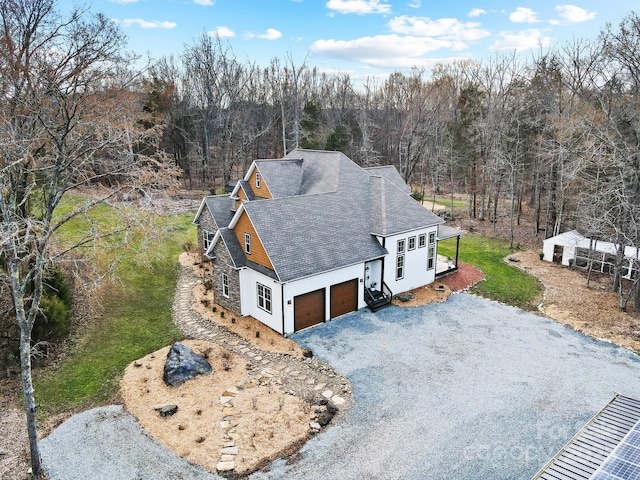 birds eye view of property with a wooded view