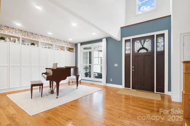 foyer with recessed lighting, baseboards, a healthy amount of sunlight, and light wood finished floors