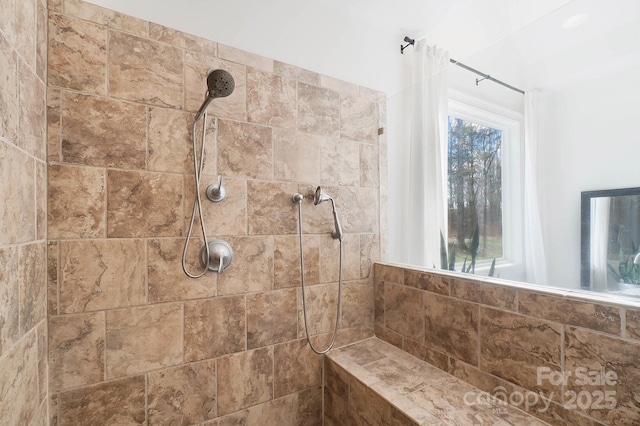 full bath featuring a tile shower