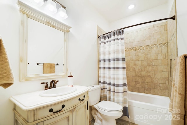 bathroom featuring shower / bath combo, vanity, and toilet