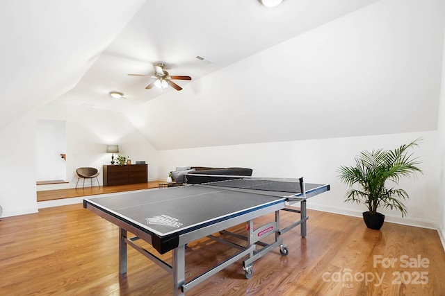 playroom featuring lofted ceiling, a ceiling fan, baseboards, visible vents, and light wood-style floors