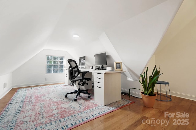 home office with baseboards, vaulted ceiling, and wood finished floors