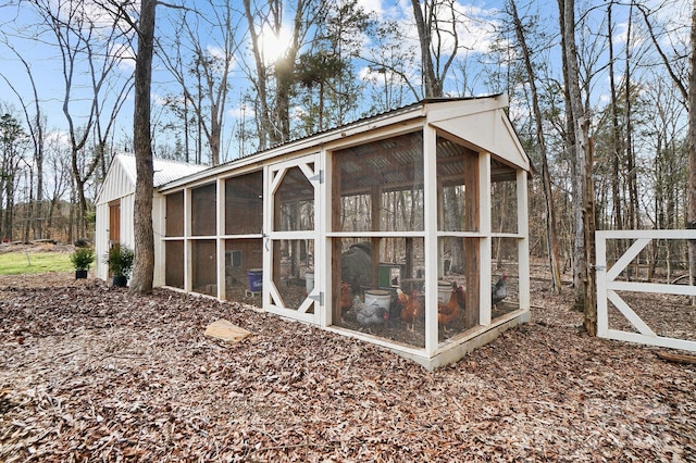 view of outdoor structure with a sunroom