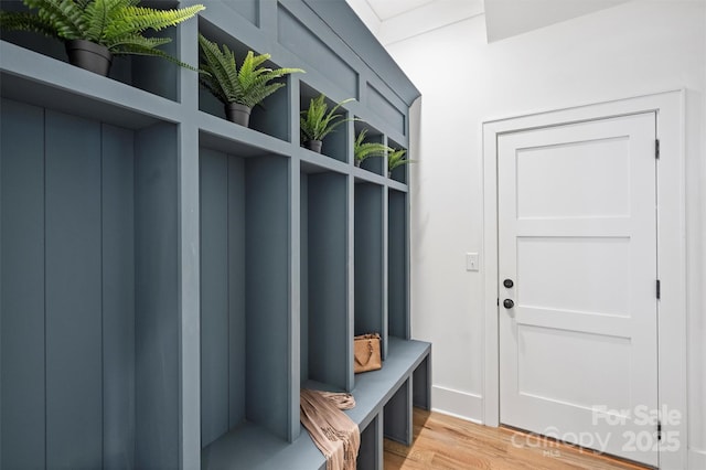 mudroom featuring elevator and light wood-style floors