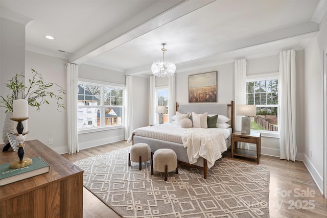 bedroom with a notable chandelier, multiple windows, wood finished floors, and baseboards