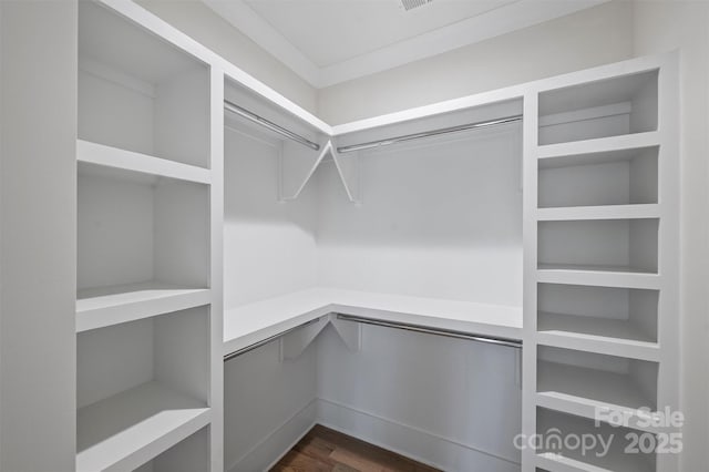 walk in closet featuring dark wood finished floors and visible vents