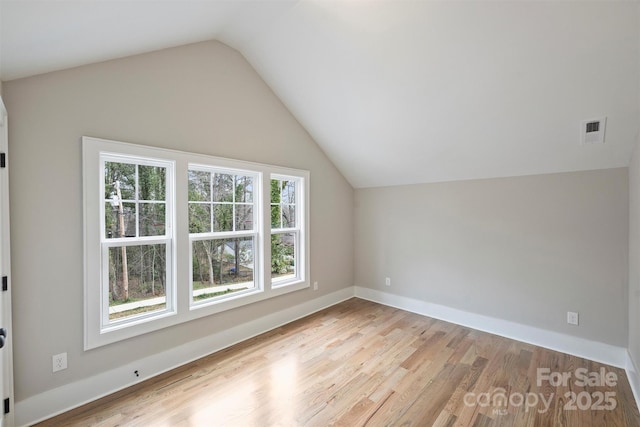 bonus room with visible vents, baseboards, lofted ceiling, and wood finished floors