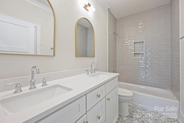 bathroom featuring a sink, toilet, shower / washtub combination, and double vanity