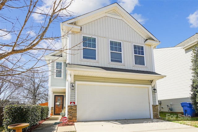 view of front facade featuring board and batten siding, concrete driveway, stone siding, and an attached garage