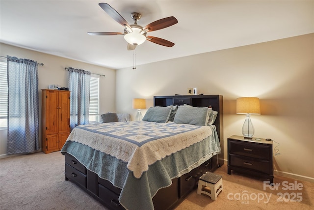 bedroom featuring a ceiling fan, light colored carpet, and baseboards