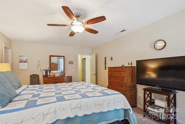 carpeted bedroom featuring ceiling fan and visible vents