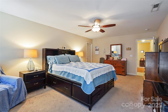 bedroom featuring light carpet, ceiling fan, visible vents, and baseboards