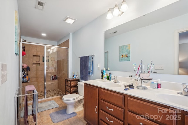 full bathroom with a stall shower, a sink, toilet, and double vanity