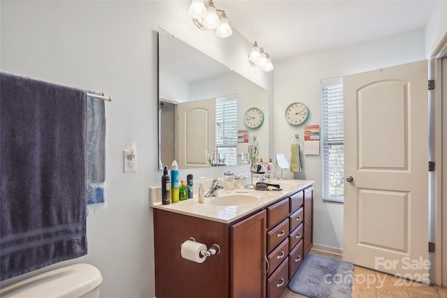 bathroom with vanity and toilet