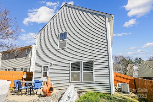 back of house featuring a patio area, fence, and central AC