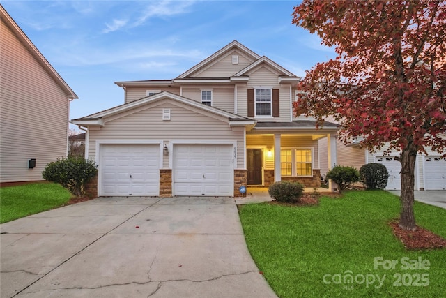 view of front of home featuring a garage, a front yard, stone siding, and driveway