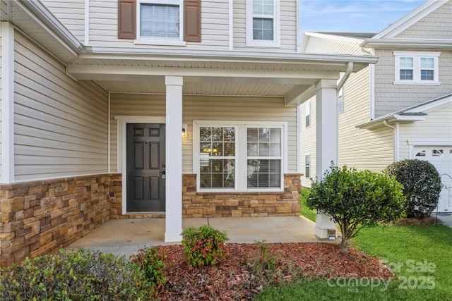 entrance to property with stone siding and a porch