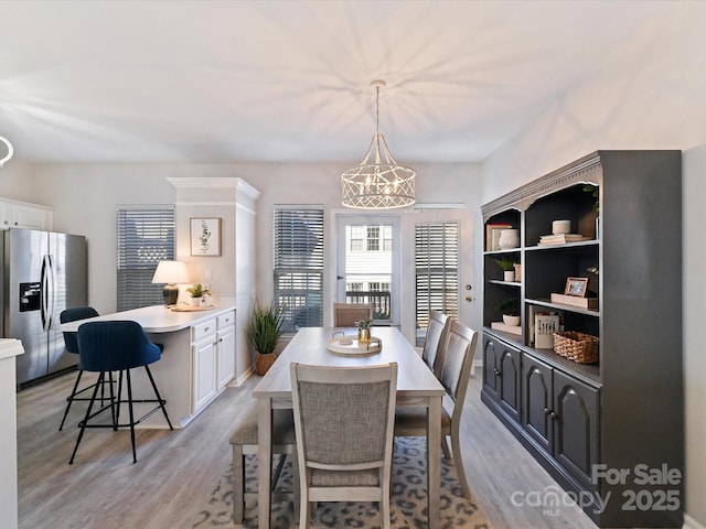 dining space with a chandelier and light wood finished floors