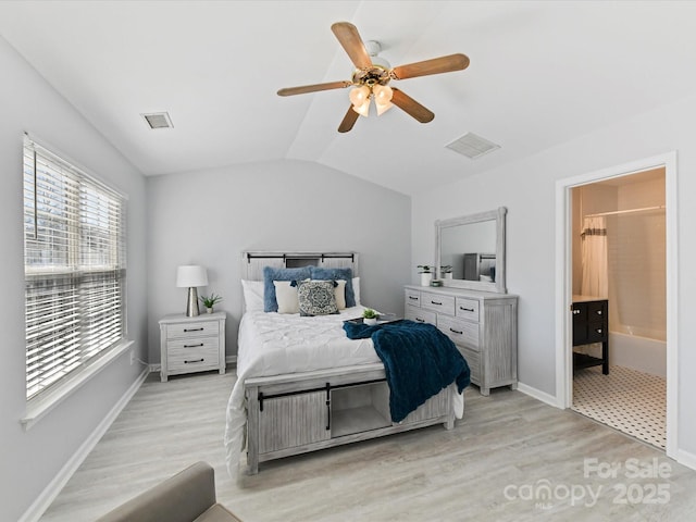 bedroom with vaulted ceiling, light wood-style flooring, and visible vents