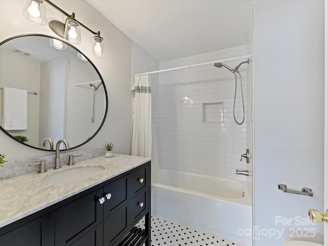 bathroom with shower / bath combo, vanity, and visible vents