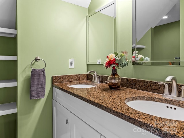 full bath featuring a sink and double vanity