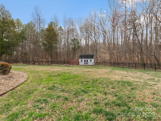 view of yard with an outbuilding, a shed, and a fenced backyard