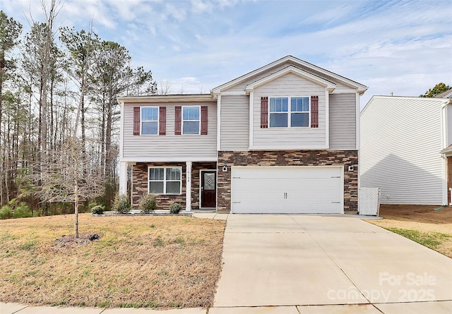 view of front facade with a front lawn, stone siding, driveway, and an attached garage