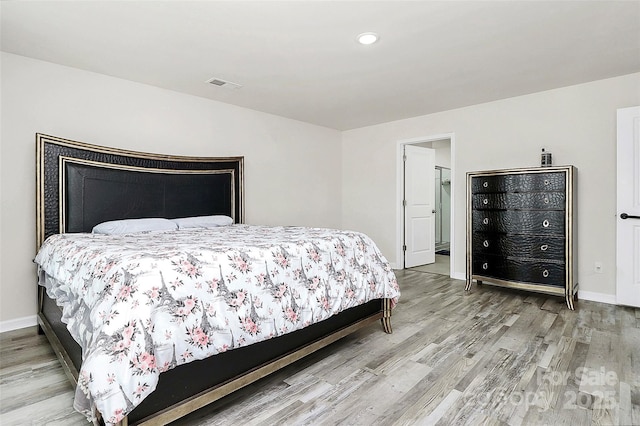 bedroom with recessed lighting, visible vents, baseboards, and wood finished floors