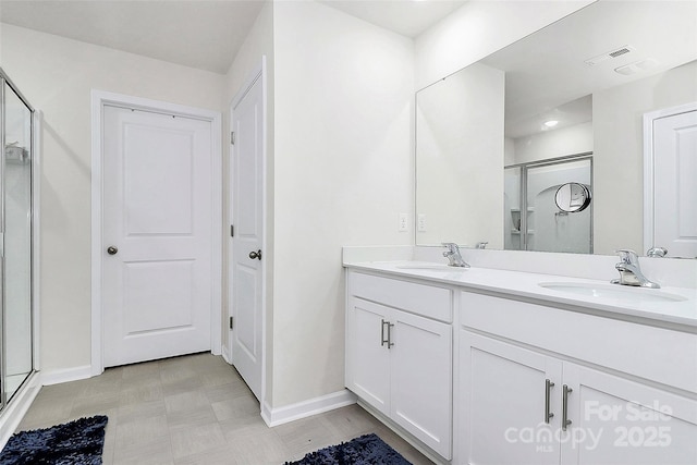 bathroom featuring a stall shower, visible vents, a sink, and double vanity