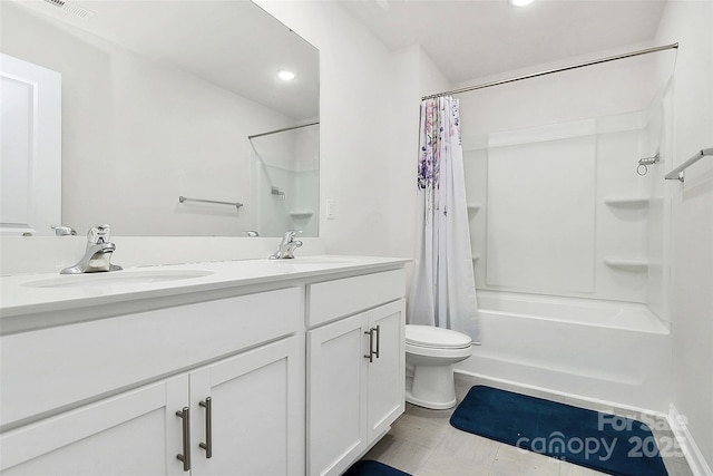 bathroom with toilet, double vanity, a sink, and visible vents