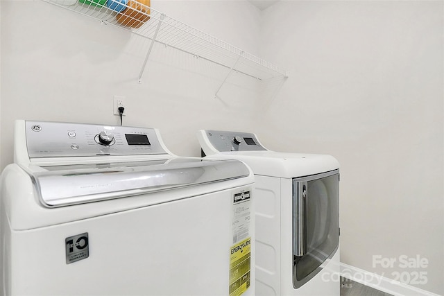 laundry area with laundry area, baseboards, and washer and dryer