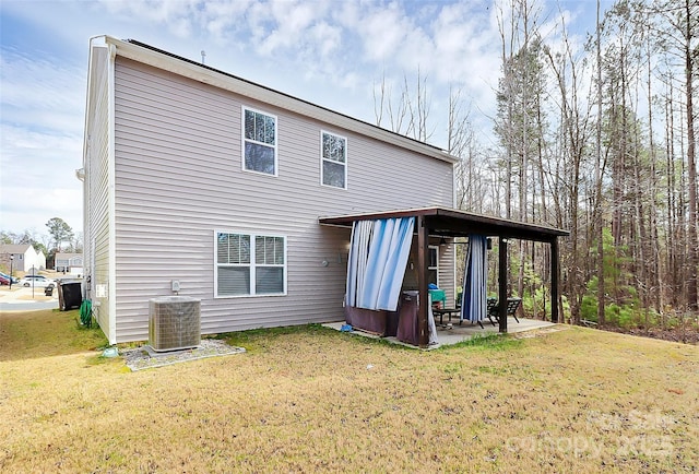 rear view of property with a yard, a patio area, and central air condition unit