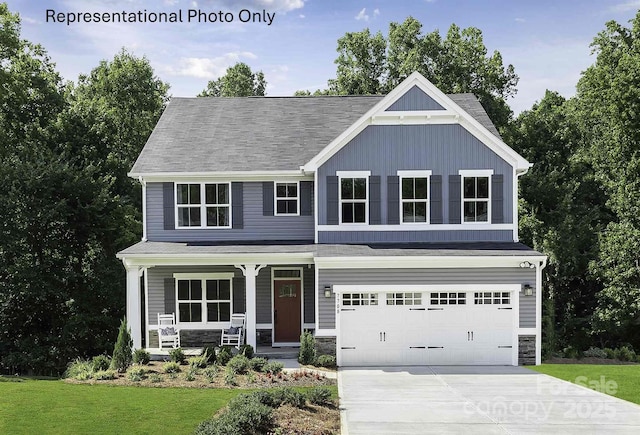 craftsman-style home featuring a garage, driveway, covered porch, board and batten siding, and a front yard