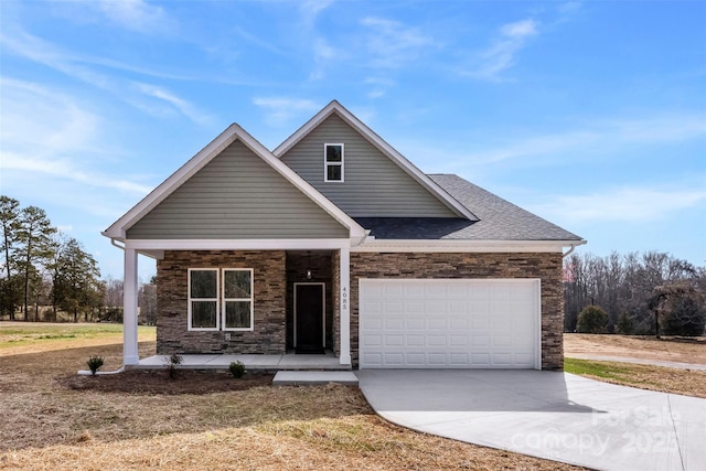 view of front of home with a shingled roof, concrete driveway, an attached garage, a porch, and a front yard