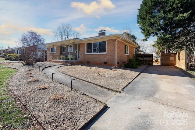 single story home with a chimney, crawl space, covered porch, fence, and brick siding