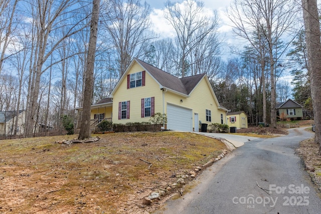 view of front of home with driveway and an attached garage