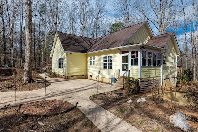 exterior space featuring entry steps, crawl space, and concrete driveway