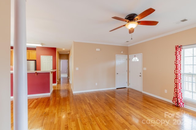 interior space with crown molding, light wood-style flooring, and baseboards