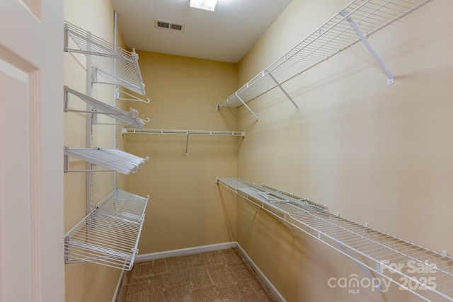 walk in closet featuring carpet floors and visible vents