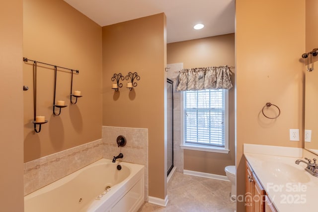 bathroom with a garden tub, toilet, vanity, baseboards, and a shower stall