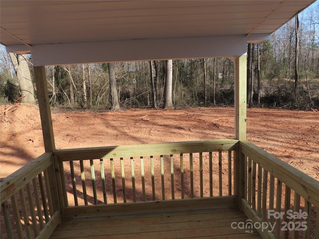 wooden terrace with a view of trees