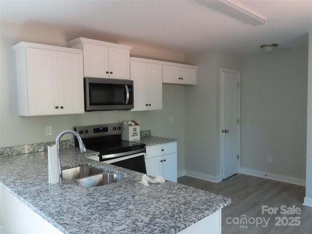635 Acre Ct, York, SC 29745 - kitchen featuring a sink, appliances with stainless steel finishes, light stone countertops, and a peninsula
