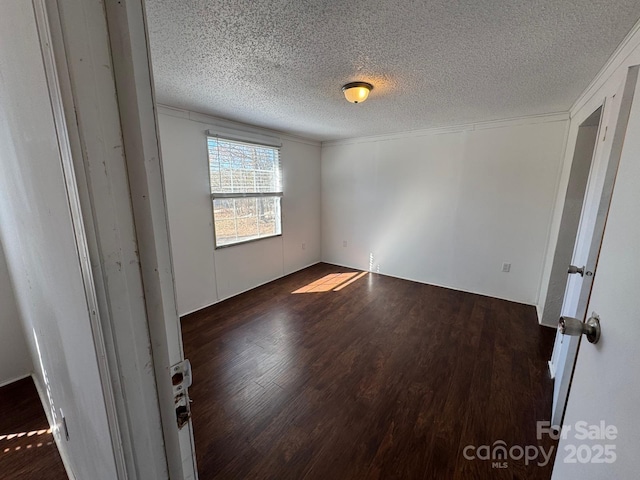 unfurnished bedroom featuring a textured ceiling and wood finished floors