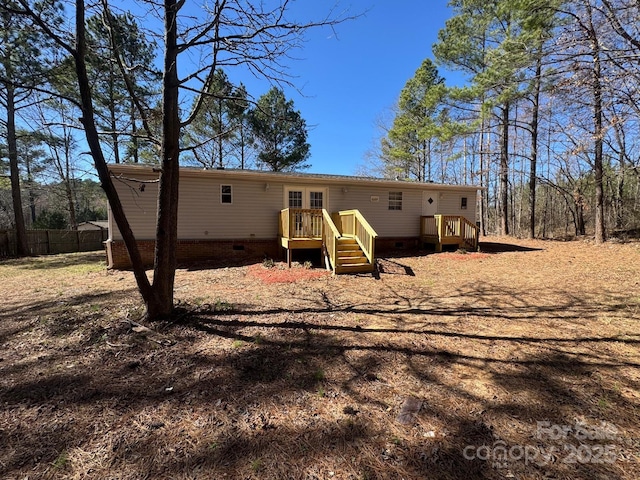 back of house featuring crawl space, fence, and a deck