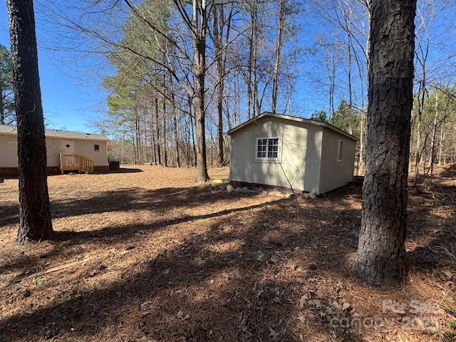 view of yard featuring an outbuilding and a deck