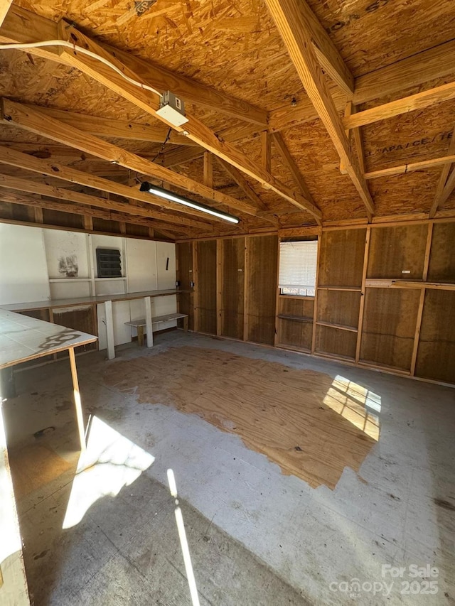 interior space with a garage and lofted ceiling